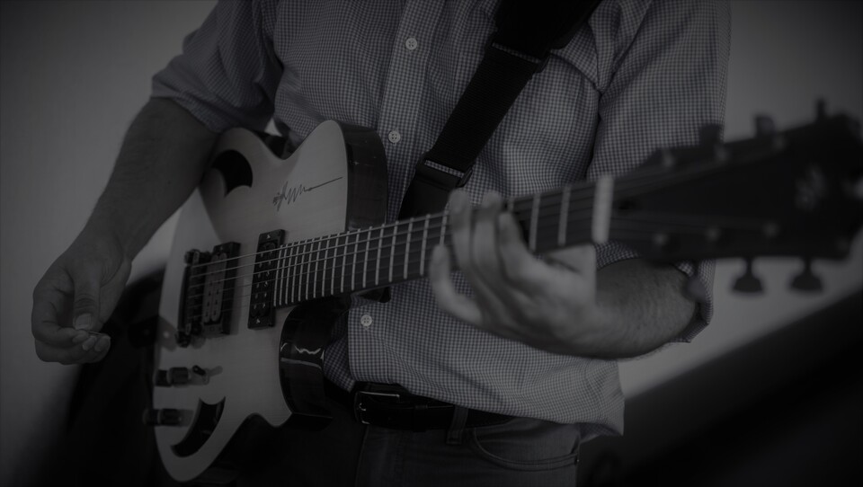 Close-up of José playing electric guitar