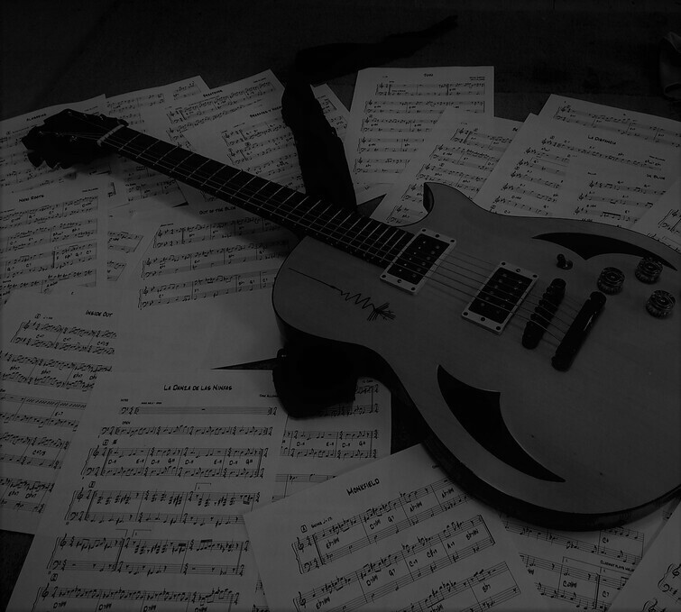 José’s guitar resting on handwritten sheet music